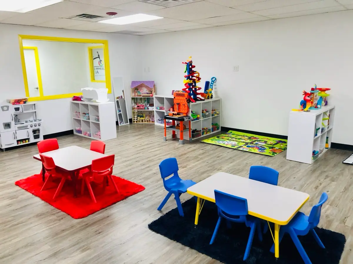 A Training Wheels ABA learning room with child-sized tables and play materials